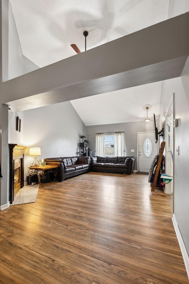 workout area with hardwood / wood-style flooring, ceiling fan, and lofted ceiling