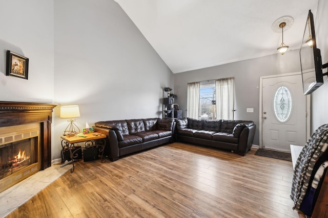 living room featuring hardwood / wood-style flooring and high vaulted ceiling