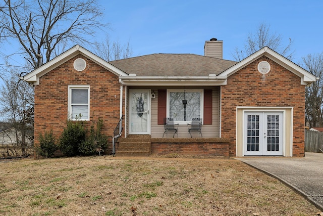 view of front of house featuring a front lawn and french doors