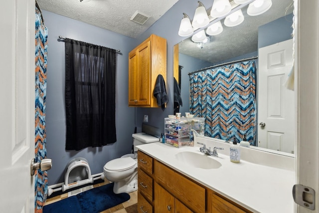 bathroom with vanity, a shower with curtain, toilet, and a textured ceiling