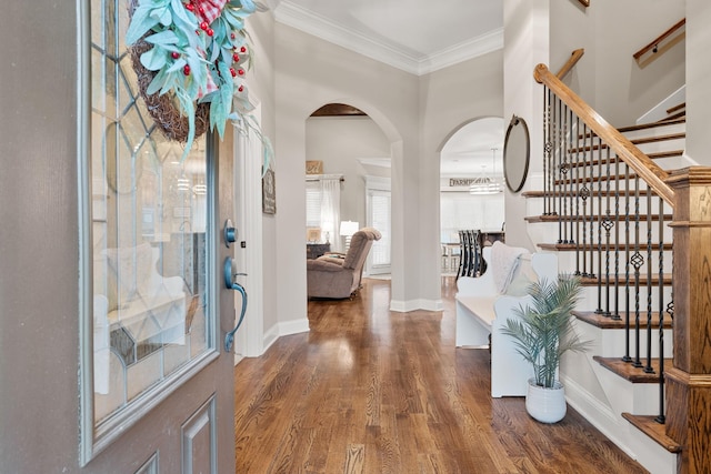 entrance foyer with crown molding and dark hardwood / wood-style flooring