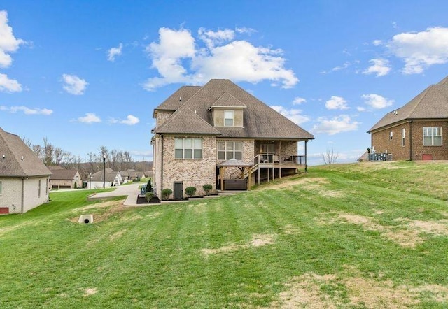 back of house with a wooden deck, a lawn, and central air condition unit