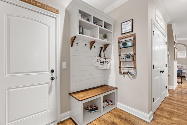 mudroom featuring crown molding and light hardwood / wood-style floors