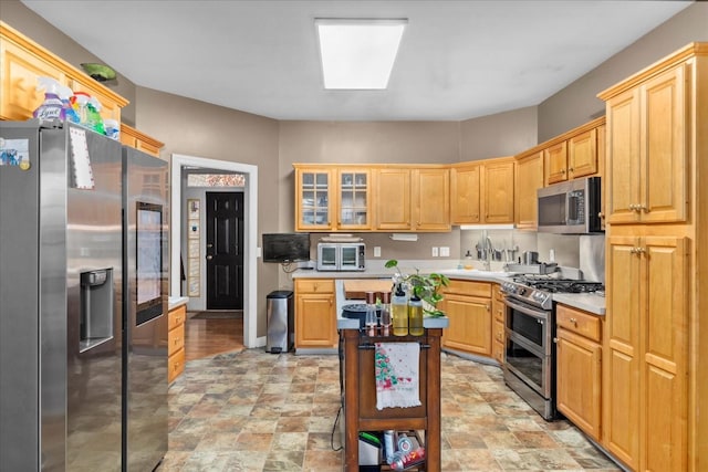 kitchen with stainless steel appliances and light brown cabinetry