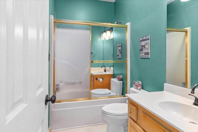 full bathroom featuring vanity, shower / bath combination with glass door, and toilet