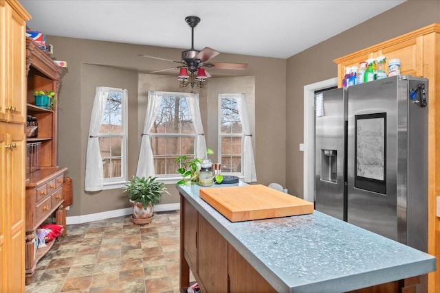 kitchen with stainless steel fridge with ice dispenser and ceiling fan