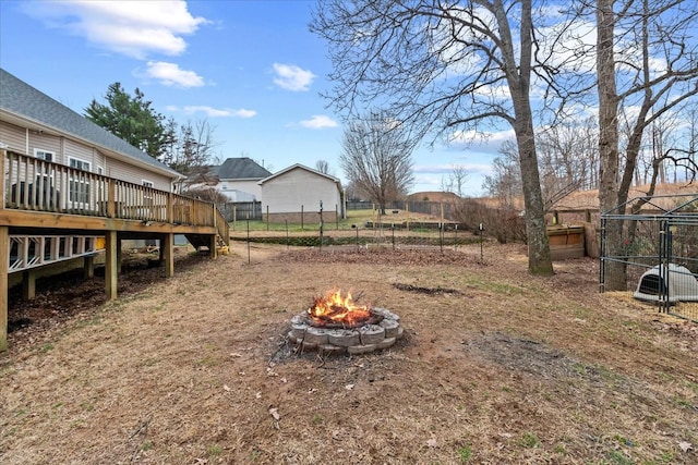 view of yard featuring a wooden deck and a fire pit