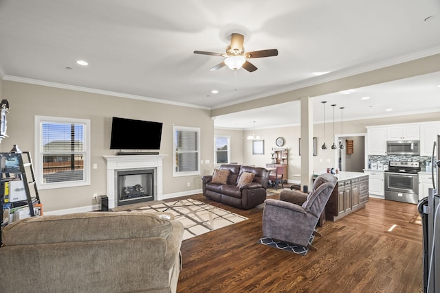 living room featuring ornamental molding, dark wood-type flooring, and ceiling fan