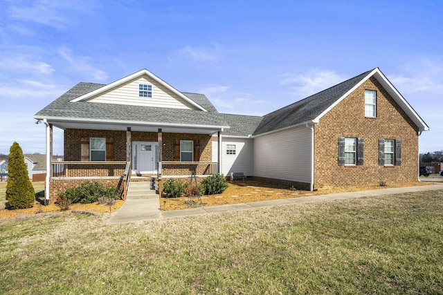 view of front of property with covered porch and a front yard