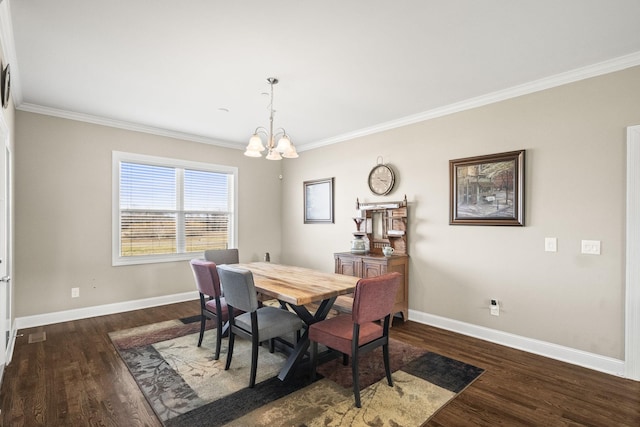 dining room with dark hardwood / wood-style flooring, ornamental molding, and an inviting chandelier