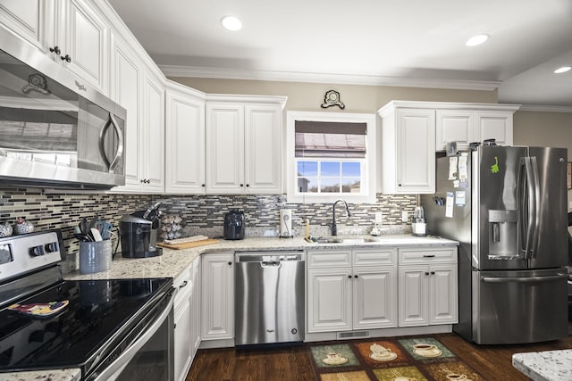 kitchen featuring sink, dark wood-type flooring, appliances with stainless steel finishes, light stone countertops, and white cabinets