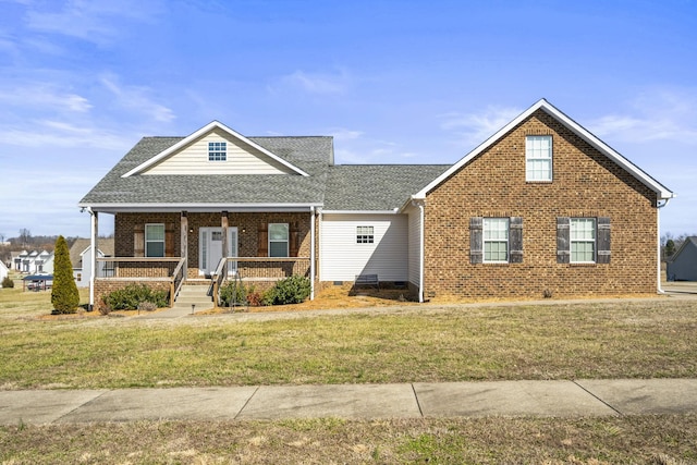 view of front of home with covered porch and a front yard