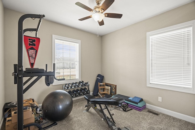 exercise room with carpet floors and ceiling fan