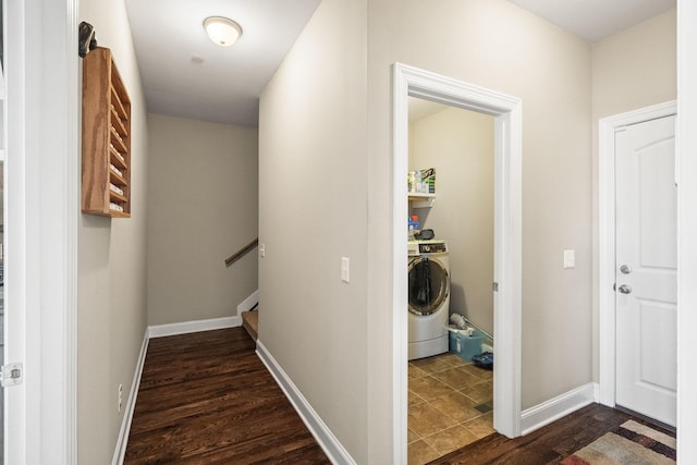 corridor with dark wood-type flooring and washer / clothes dryer