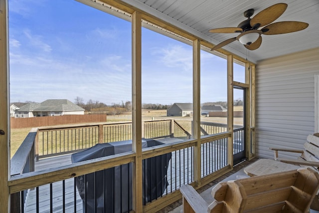 sunroom featuring ceiling fan