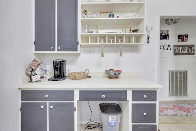 bar featuring gray cabinetry