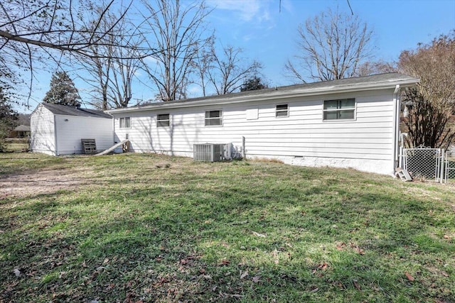 back of property featuring a yard and central AC unit