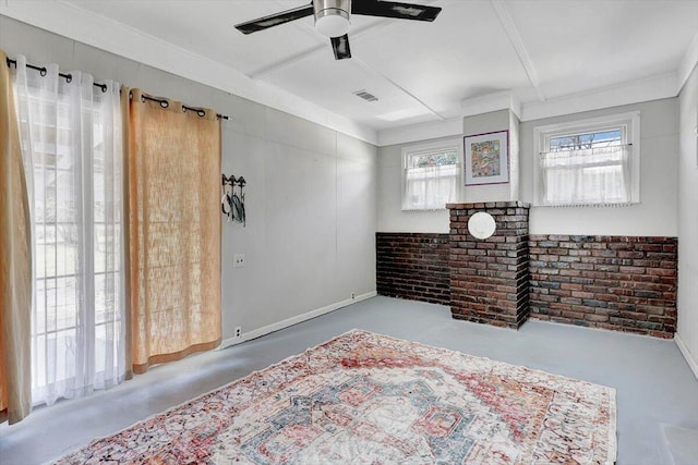 interior space featuring brick wall, concrete floors, and ceiling fan