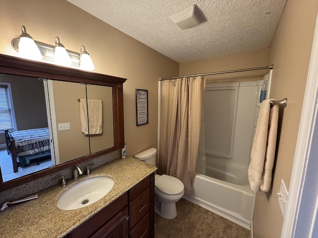 full bathroom featuring tile patterned flooring, vanity, toilet, shower / bath combo, and a textured ceiling