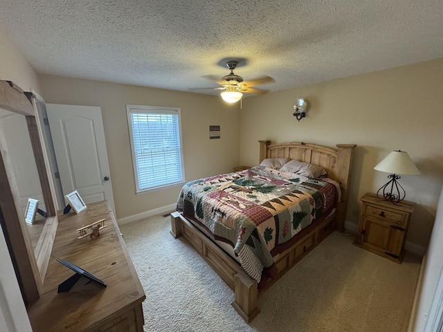 bedroom with light carpet, ceiling fan, and a textured ceiling