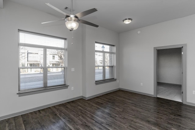 unfurnished room with dark wood-type flooring and ceiling fan