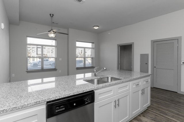 kitchen with white cabinetry, dishwasher, light stone countertops, and sink