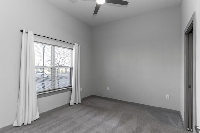 carpeted empty room featuring ceiling fan