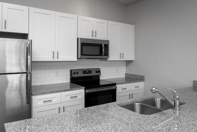 kitchen featuring white cabinetry, appliances with stainless steel finishes, sink, and decorative backsplash