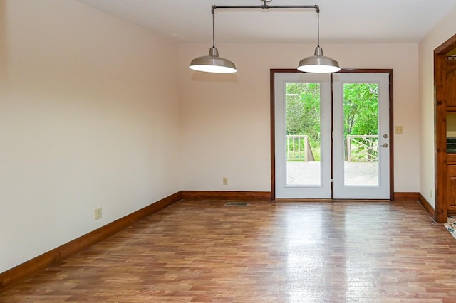 unfurnished room with hardwood / wood-style flooring