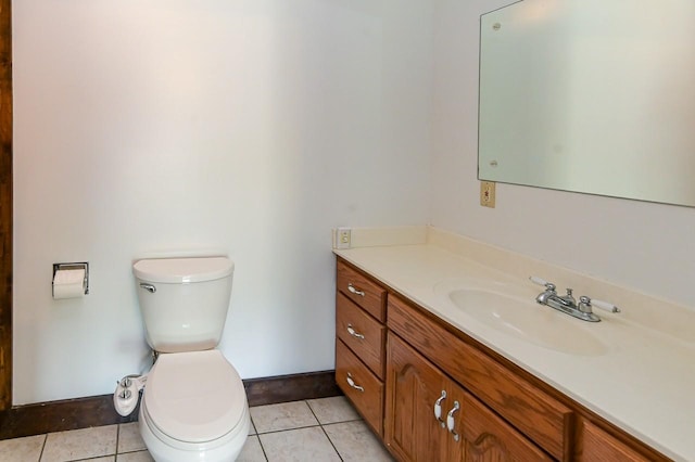 bathroom featuring vanity, tile patterned floors, and toilet