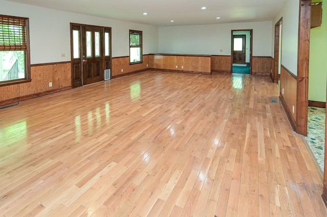 interior space featuring wooden walls and light wood-type flooring