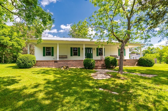 single story home featuring covered porch and a front lawn