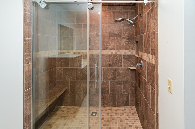 bathroom with a shower with shower door