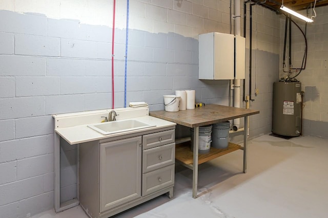 basement featuring sink and water heater