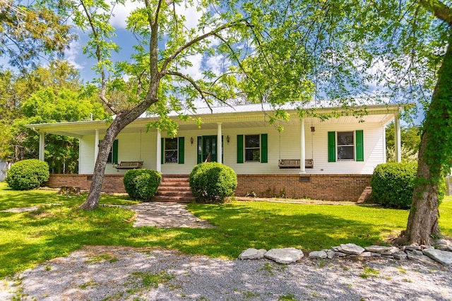 single story home with covered porch and a front yard