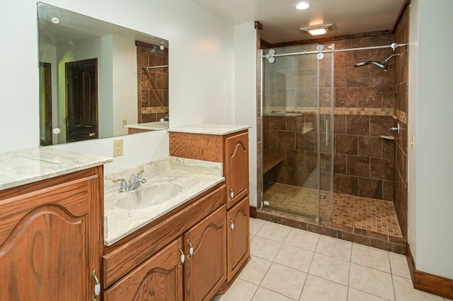 bathroom with vanity, a shower with door, and tile patterned floors