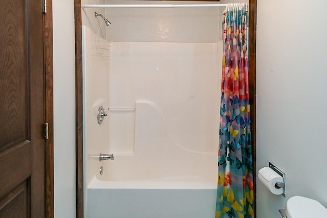 bathroom with shower / bath combo and toilet