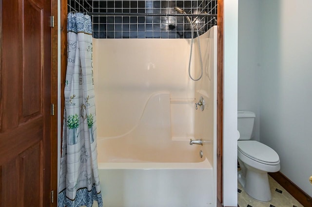 bathroom featuring shower / tub combo and toilet