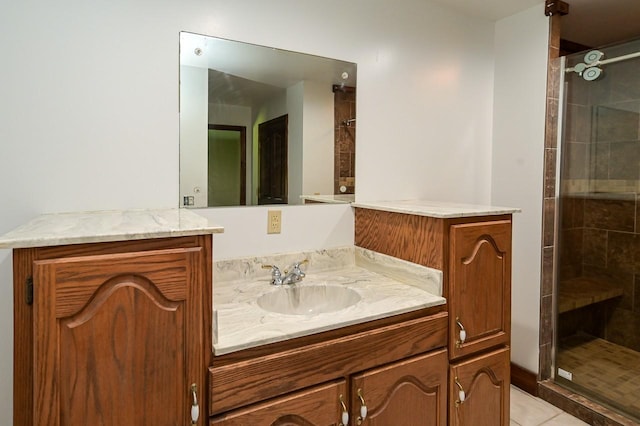 bathroom with vanity and a shower with door