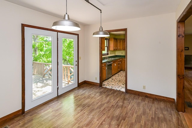 unfurnished dining area featuring dark hardwood / wood-style flooring and sink