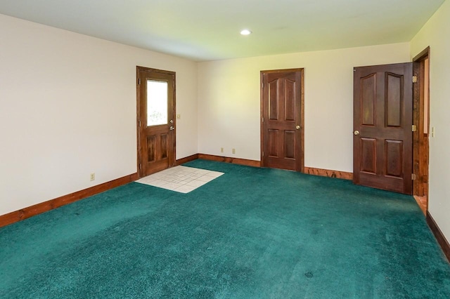 unfurnished room featuring dark carpet