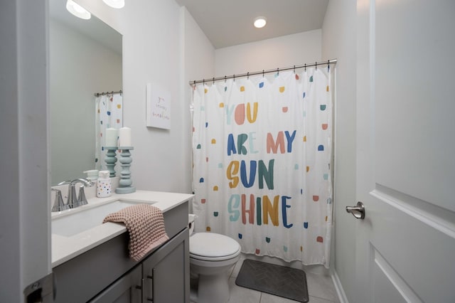 bathroom with tile patterned flooring, vanity, walk in shower, and toilet