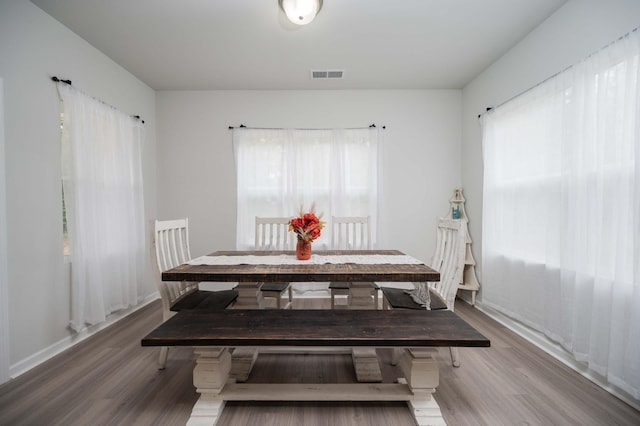 dining area with hardwood / wood-style flooring and plenty of natural light