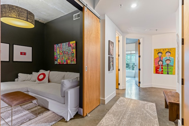 interior space with concrete flooring and a barn door