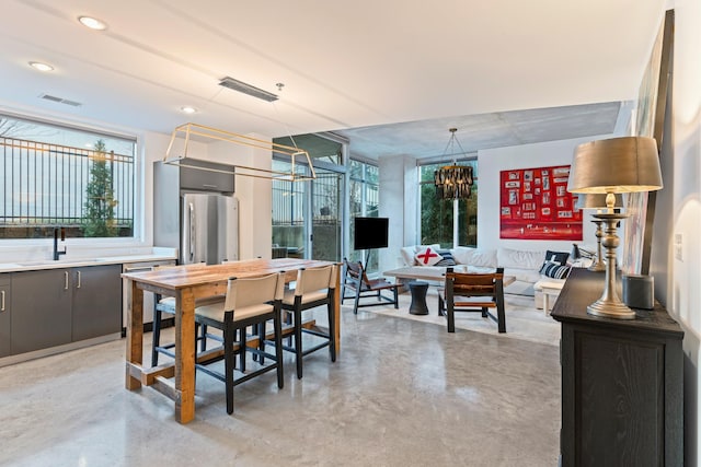 dining area with a chandelier and sink