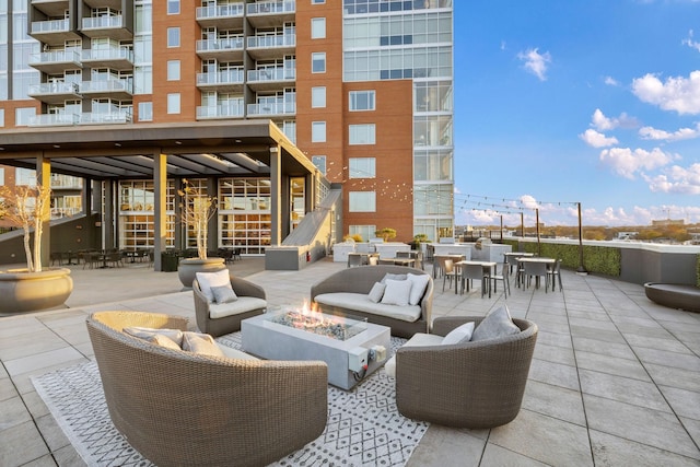 view of patio / terrace with an outdoor living space with a fire pit