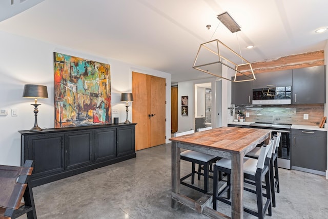 kitchen featuring stainless steel electric range and decorative backsplash