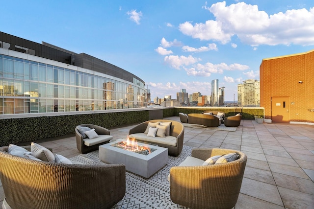 view of patio / terrace with an outdoor living space with a fire pit