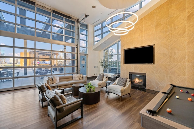 interior space featuring hardwood / wood-style flooring, a wall of windows, and a tile fireplace