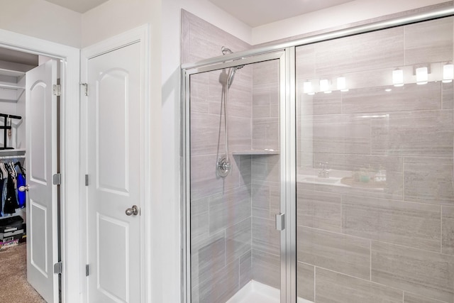 bathroom with a shower with door